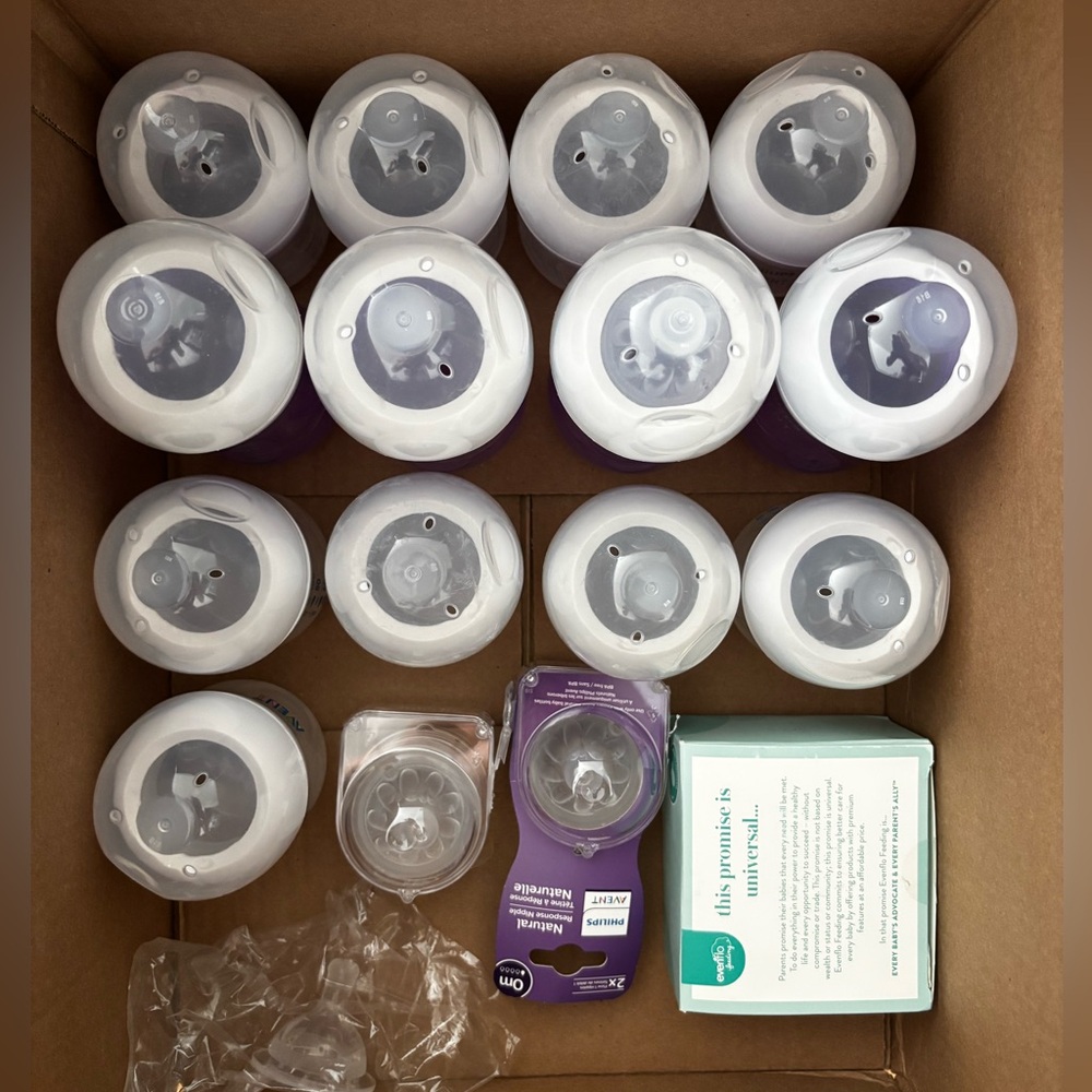 Lots of wide baby bottles and nipples